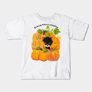 Peeking between pumpkins Kids T-Shirt